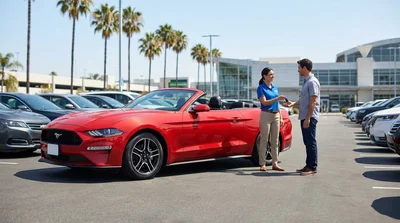 Customer handing a credit card to an agent at a California car rental counter