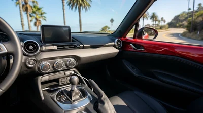 Close-up of a smartphone plugged into a dashboard USB charging port inside a California car rental