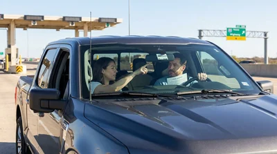 Customer examining a toll tag at a car rental counter in Texas