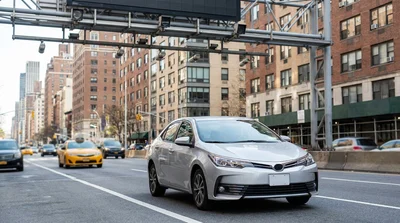 White car rental driving through heavy traffic on a busy avenue in downtown New York