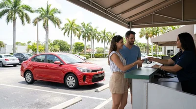 Customer handing a credit card to an agent at a Miami car hire counter