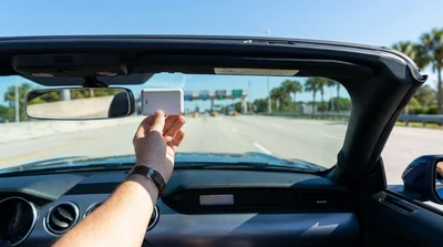 Interior view of a car rental in Florida with a SunPass transponder attached to the windshield