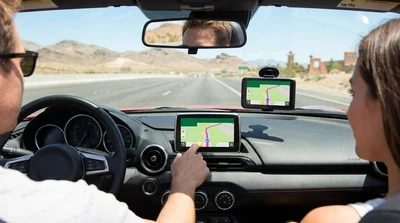 Illuminated dashboard GPS screen inside a car rental navigating the Las Vegas streets