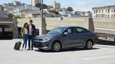 A traveler receiving keys from an agent at a car rental desk in San Francisco