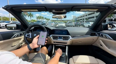 Hand touching the Apple CarPlay screen on the dashboard of a car rental in Miami