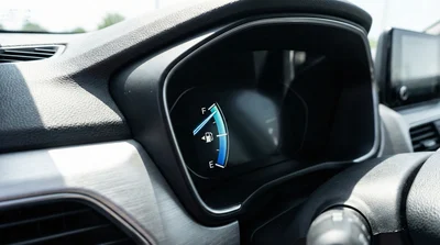 Close-up of a car dashboard showing a full gas tank gauge, illustrating the full-to-full fuel policy for car rentals.
