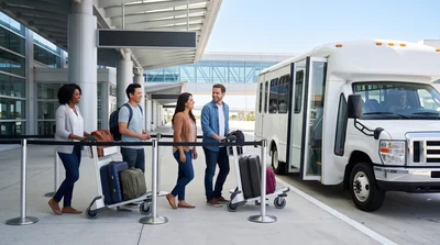 A diverse group of travelers happily queue for an unbranded airport shuttle in bright Orlando daylight.