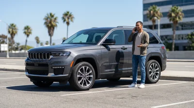 A driver in Los Angeles uses a phone for roadside assistance service next to a rental SUV.
